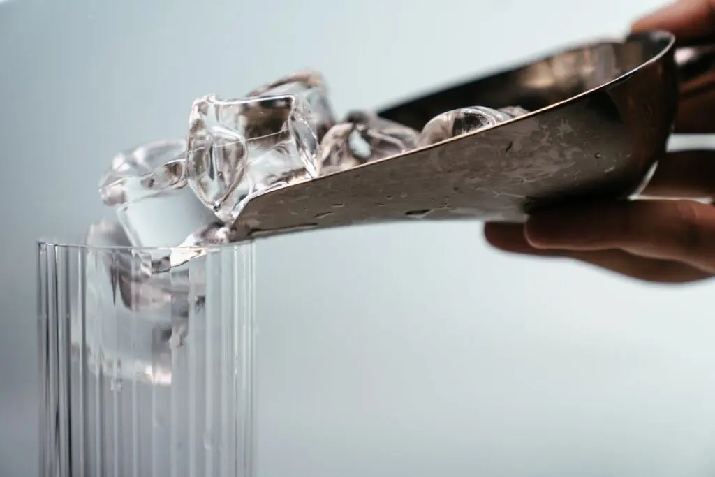 A person cutting ice with scissors.